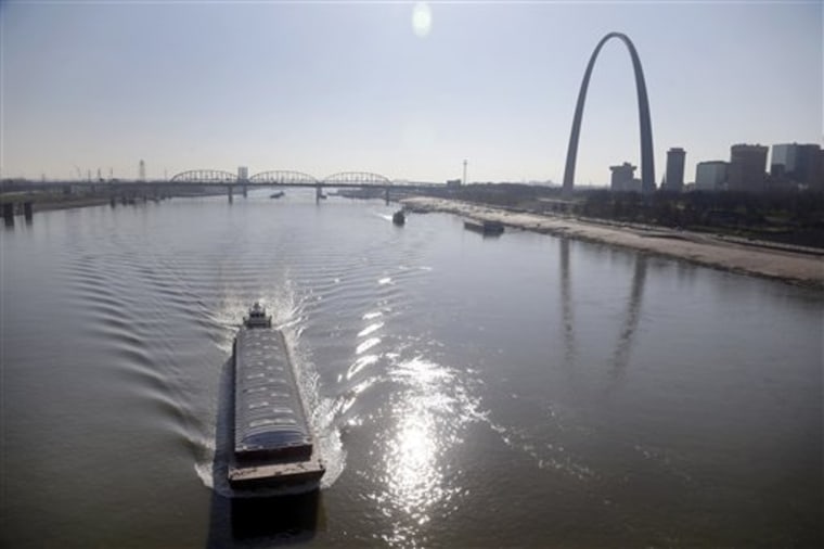A barge powers its way up the Mississippi River on Friday in St. Louis. 